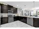 Stylish kitchen featuring dark wood cabinets, stainless steel appliances, and a large breakfast bar at 1560 Maidstone Ct, Davenport, FL 33896