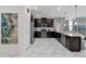 Well-equipped kitchen with dark cabinetry and a full suite of stainless steel appliances at 1560 Maidstone Ct, Davenport, FL 33896