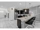 Spacious kitchen with dark cabinetry and stainless steel appliances at 1560 Maidstone Ct, Davenport, FL 33896
