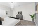 Spacious main bedroom with tv, plant, plush carpeting, and modern lighting fixture at 1560 Maidstone Ct, Davenport, FL 33896