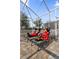 Relaxing outdoor seating area with lounge chairs, covered by a screened enclosure at 1560 Maidstone Ct, Davenport, FL 33896