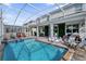 Beautiful pool area with lounging space, lush greenery, and a screened enclosure at 1560 Maidstone Ct, Davenport, FL 33896