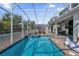 Sparkling pool with a screened enclosure and ample seating, great for Gathering fun at 1560 Maidstone Ct, Davenport, FL 33896