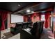 Impressive home theater with a large screen, cozy seating, and themed decor for an immersive entertainment space at 1560 Maidstone Ct, Davenport, FL 33896