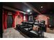 Stunning theater room featuring comfortable seating, brick accent walls, and a projector for an immersive viewing experience at 1560 Maidstone Ct, Davenport, FL 33896
