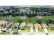Stunning aerial view of the home in a desirable neighborhood, highlighting proximity to the golf course and community amenities at 1590 The Oaks Blvd, Kissimmee, FL 34746