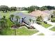 Aerial view showcasing a single-Gathering home with tropical landscaping and adjacent golf course at 1590 The Oaks Blvd, Kissimmee, FL 34746