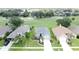 Aerial view of a well maintained single Gathering home with manicured lawns and tropical landscaping at 1590 The Oaks Blvd, Kissimmee, FL 34746
