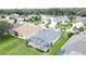 Aerial view of a screened-in porch and backyard at 1590 The Oaks Blvd, Kissimmee, FL 34746