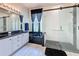 Modern bathroom features double vanity, soaking tub, and walk-in shower with glass enclosure for a luxurious feel at 1590 The Oaks Blvd, Kissimmee, FL 34746