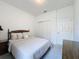 Comfortable bedroom features a decorative headboard, bureau and double door closet storage at 1590 The Oaks Blvd, Kissimmee, FL 34746