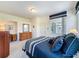 Bright bedroom features a comfortable bed, natural light, and dresser with mirror for a relaxing retreat at 1590 The Oaks Blvd, Kissimmee, FL 34746