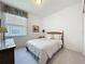 Comfortable bedroom features a decorative headboard, dresser and bureau with natural lighting at 1590 The Oaks Blvd, Kissimmee, FL 34746