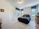Bright bedroom features a comfortable bed, natural light, and neutral carpet for a relaxing retreat at 1590 The Oaks Blvd, Kissimmee, FL 34746
