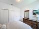 Well-lit bedroom with double door closet and bureau, and room for storage at 1590 The Oaks Blvd, Kissimmee, FL 34746