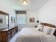 Comfortable carpeted bedroom featuring a large dresser, bureau, and ample natural lighting at 1590 The Oaks Blvd, Kissimmee, FL 34746