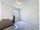 Carpeted bedroom provides a dedicated workspace with a built in desk and natural light at 1590 The Oaks Blvd, Kissimmee, FL 34746