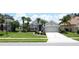 Well-manicured single-Gathering home with palms and a two car garage at 1590 The Oaks Blvd, Kissimmee, FL 34746