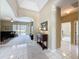 Open foyer showcasing tile floors, a view into the living room, and tasteful decor at 1590 The Oaks Blvd, Kissimmee, FL 34746