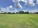 Expansive view of the manicured green golf course at 1590 The Oaks Blvd, Kissimmee, FL 34746