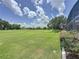 Serene golf course view with lush green grass at 1590 The Oaks Blvd, Kissimmee, FL 34746