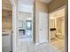 Hallway view with tile floors leading to a laundry area and a bathroom at 1590 The Oaks Blvd, Kissimmee, FL 34746