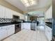 Well-equipped kitchen featuring stainless steel appliances and a view to the living room at 1590 The Oaks Blvd, Kissimmee, FL 34746