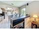 Stylish kitchen featuring a breakfast bar, modern lighting, and a cozy fireplace at 1590 The Oaks Blvd, Kissimmee, FL 34746