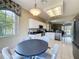 Eat-in kitchen boasts black countertops, white cabinets and stainless steel appliances at 1590 The Oaks Blvd, Kissimmee, FL 34746