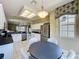 Spacious eat-in kitchen features stainless steel appliances, and adjacent living area at 1590 The Oaks Blvd, Kissimmee, FL 34746