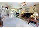 Inviting living room featuring neutral walls, tiled floors in entry and kitchen views at 1590 The Oaks Blvd, Kissimmee, FL 34746