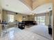 Spacious living room with tile flooring, comfortable seating, and sliding glass doors to outdoor patio at 1590 The Oaks Blvd, Kissimmee, FL 34746