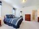 Well-lit carpeted main bedroom with walk-in closet, ensuite bathroom and ample space at 1590 The Oaks Blvd, Kissimmee, FL 34746