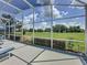 View from screened in patio overlooking a lush golf course at 1590 The Oaks Blvd, Kissimmee, FL 34746