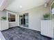 Covered patio with neutral colors offers a cozy space for outdoor relaxation and entertaining guests at 1590 The Oaks Blvd, Kissimmee, FL 34746