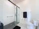 Sleek walk-in shower boasts modern tile, glass enclosure, and stylish fixtures for a spa-like experience at 1590 The Oaks Blvd, Kissimmee, FL 34746