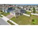 Aerial shot showcasing a home with solar panels, well-kept lawn, and paved driveway at 168 Jensen Dr, Groveland, FL 34736