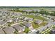 An aerial view of a planned community showcasing the layout and proximity to green spaces and ponds, for recreation at 168 Jensen Dr, Groveland, FL 34736