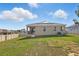 Expansive backyard with lush green grass, patio area, and privacy fence at 168 Jensen Dr, Groveland, FL 34736