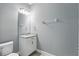 Clean powder room with a sleek vanity, large mirror, and modern fixtures at 168 Jensen Dr, Groveland, FL 34736