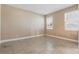 Cozy bedroom with neutral paint, tile floors, and bright windows at 168 Jensen Dr, Groveland, FL 34736