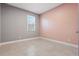 Cozy bedroom with tile flooring, a window, and fresh paint, creating a welcoming and comfortable space at 168 Jensen Dr, Groveland, FL 34736