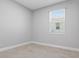 Bright bedroom with a window and tile flooring, offering a simple and versatile living space at 168 Jensen Dr, Groveland, FL 34736