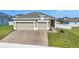 Beautiful home with a paved driveway, well-kept lawn, and landscaped garden beds at 168 Jensen Dr, Groveland, FL 34736