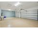 Large three-car garage with epoxy flooring, ample storage, and modern garage door openers at 168 Jensen Dr, Groveland, FL 34736