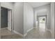 Inviting hallway featuring neutral paint, tile flooring, and easy access to the home's living spaces at 168 Jensen Dr, Groveland, FL 34736