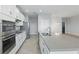 Modern kitchen with stainless steel appliances, a gray countertop island, and white cabinetry at 168 Jensen Dr, Groveland, FL 34736