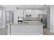 Spacious kitchen featuring white cabinetry, a center island, and stainless steel appliances at 168 Jensen Dr, Groveland, FL 34736