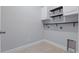 Clean laundry room with modern black shelving and tile floors; utility connections for easy setup at 168 Jensen Dr, Groveland, FL 34736
