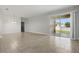 Open living room featuring tile floors, a sliding glass door to the backyard, and neutral paint at 168 Jensen Dr, Groveland, FL 34736